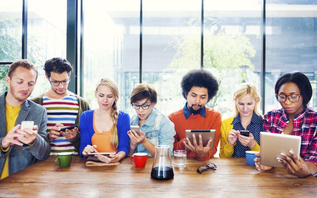 Group-of-People-Using-Mobile-Devices-iStock_000040645286_Medium-min