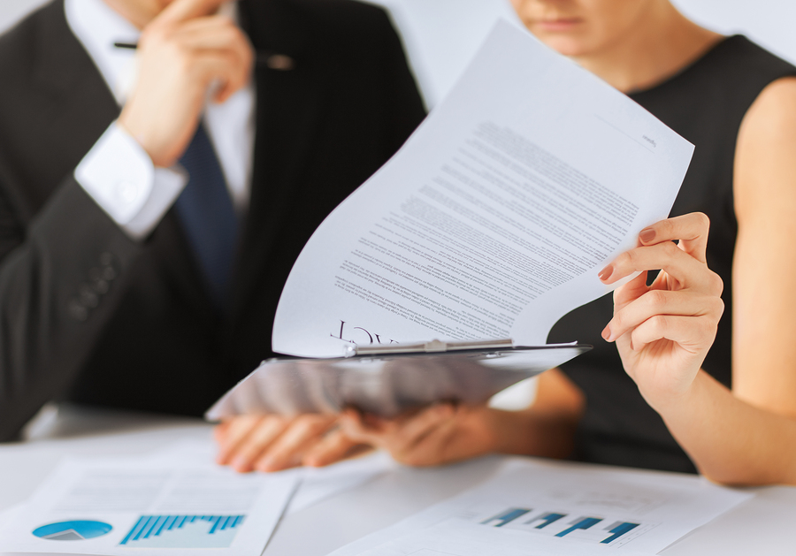 business, office, law and legal concept - picture of man and woman hand signing contract paper